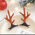 Pair of festive orange velvet reindeer antler hair clips on a holiday decorative plate - Simple Brown Antlers Pair