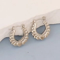 Detailed close-up of silver geometric hoop earrings with embossed heart patterns on the rim - Silver Style K7-53
