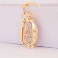 Golden golf bag keychain with sparkling rhinestones and a polished metal finish - White