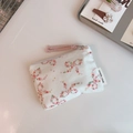 Detailed macro view of a floral cotton coin purse with pink bow prints and zipper - Colorful Floral Bow