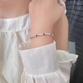 Elegant silver tube bracelet with red beads on female wrist for a minimalist style - Silver Metal Tube Red Bead (MY37349)
