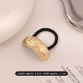 Minimalist golden alloy hair tie with irregular textured metal plate and black elastic - Curved Embossed Circle Gold