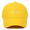 Detailed close-up of CAT DAD white embroidery on a vibrant yellow cotton baseball cap - Adjustable / Yellow
