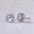 Silver halo stud earring featuring a brilliant round zircon on a purple background - Round Halo