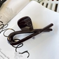 Close-up of deep brown resin hair claw clip on magazine with polished glossy finish - Butterfly Buckle Ribbon (Approx 12cm) / Chocolate