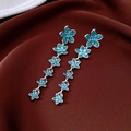 Close-up of vintage flower drop earrings with turquoise zircons on velvet - Silver Pin Blue Five-petal Flower Drop