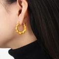 Minimalist gold-plated sunflower hoop earrings worn by a model in a close-up professional shot - Gold (F1195-Gold Earrings)