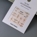 Macro shot of gold-plated K9 nail crystals on a white display card model MJ-011 - MJ-011 Gold Foil (Flower & Geometry)