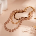 Detail of champagne acrylic beads and layered chain structure with crackle finish - Gold