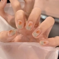 Short press-on nails featuring artistic orange and green gradient blend finish - R720 Mint Amber / Nail Glue Version