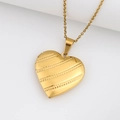 Golden heart locket necklace with etched diagonal stripes on a minimalist metal surface - Twill Heart/Gold