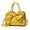 Chic lemon yellow crocodile embossed handbag with oversized bow detail and top handles - Yellow