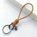 Orange-brown hand-braided leather keychain with dark gray metal shackle and keyring - Natural Leather Silver Horseshoe Buckle with Bead