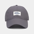 Detail of dark grey baseball cap featuring mesh panels and vintage embroidered logo patch - Adjustable / Gray