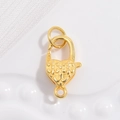 Macro detail of S925 sterling silver heart lobster clasp with floral engraving and gold finish - Gold Heart Petal Lobster Clasp