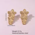 Golden stainless steel triple flower drop earrings on purple backdrop, 4.23cm height - Triple Graduated Flower (FYD6091)