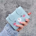 Short light blue tri-fold wallet for women with cute bunny design and buckle closure - Blue