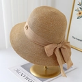 Detail of hand-woven straw hat with chiffon bow and gold buckle on display stand - Khaki With Khaki Ribbon