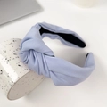 Solid light blue knotted fabric headband displayed on a ceramic mug for women - Sky Blue 17.5CM