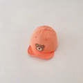 Detailed close-up of soft cotton orange baby baseball cap with cute bear embroidery - Orange