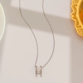 Macro detail of silver titanium steel necklace with sparkling H-shaped pendant - Iced Out H Style (8806) / Silver