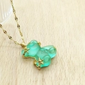 Close-up of translucent mint green resin bear pendant with gold stars on water wave chain - Green Lip Chain