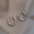 Minimalist silver pleated texture metal hoop earrings on light silk background - Silver Crumpled Hoop