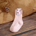 Close-up of pink baby sock with 3D white bunny doll and non-slip sole lettering - XS / Light Pink Rabbit