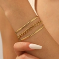 Three-layer 18K gold plated titanium steel chain bracelet shown on a female wrist - Gold A720