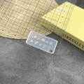 Macro view of translucent silicone mold showing seashell designs with a ruler for size - 173# Conch Shell