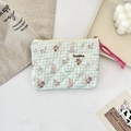 Detail of blue plaid quilted pouch with rabbit prints and a soft zipper closure - Salt Style Bunny