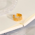 Detailed close-up of adjustable gold ring featuring embossed leaf patterns on an open book - Floral Relief Open Ring