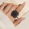 Close-up of a glamorous black crystal sunflower ring featuring a bold geometric rhinestone design - Adjustable Open / Black Sunburst Flower Style (6059BK)