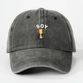 Detail of grey washed denim baseball cap featuring yellow trophy print and BOY lettering - One Size / Black