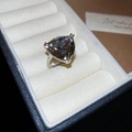 Macro shot of a silver ring featuring a large triangle-cut smoky grey gemstone in a jewelry box - Triangle Smoke Grey Main Stone Ring(HR2689-HR2690) / Silver-Grey