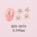 Macro detail of 9.5x8mm bow nail charms with pink heart crystals and gold metal base - Gold Bow + Pink Heart Stone (9979)
