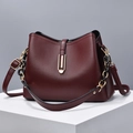 Elegant burgundy textured leather shell bag with golden hardware and black chain detail - Burgundy