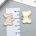 Pink polka dot bow alloy charm in gold finish with front and back views for jewelry DIY - Pink Polka Dot Bowknot Tie