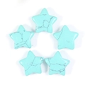 Macro view of five turquoise star-shaped stones with natural black vein patterns - Turquoise Howlite