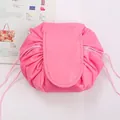 Portable bright pink drawstring makeup bag with folding cover on a fashion magazine - Deep Pink