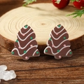 Detail of Christmas tree stud earrings with gingerbread texture on rustic wood background - Brown Gingerbread