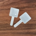 Two small white plastic measuring spoons for powder on dark wood background - 15g Square (9.8*4.6*2.3cm) / White