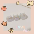 Macro detail of three purple marbled acetate cat hair clips with golden facial features - Starry Aqua Blue Cat