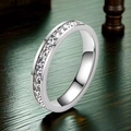 Close-up of sparkling silver eternity ring with square cubic zirconia stones on wood - XS / Eternity Band Style / Steel