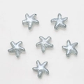 Macro detail of six grey starfish glass beads with textured facets for DIY jewelry - Pack of 30 / Light Blue Grey