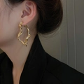 Elegant gold twisted geometric hoop earrings with striped texture shown on a female model - Gold Irregular Twisted Style (19#)