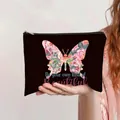 Handheld black canvas makeup bag featuring colorful floral pattern and motivational text - Colorful Butterfly Inspirational Slogan (jiayingpbb0334)
