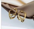 Three-layer heart-shaped golden metal earrings displayed on premium brown silk fabric - Multi-Layer Stereo Heart Earrings (E4394)