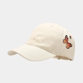 Detailed side view of beige baseball cap featuring an embroidered butterfly design - Adjustable / Beige