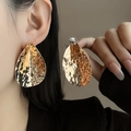 Detailed view of large gold teardrop earrings with irregular hammered metal texture - E5201-2 Hammered Waterdrop Large / Gold